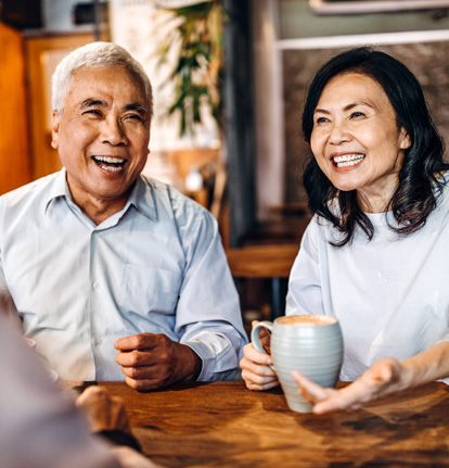 An image of an older couple having an conversation with someone out of view